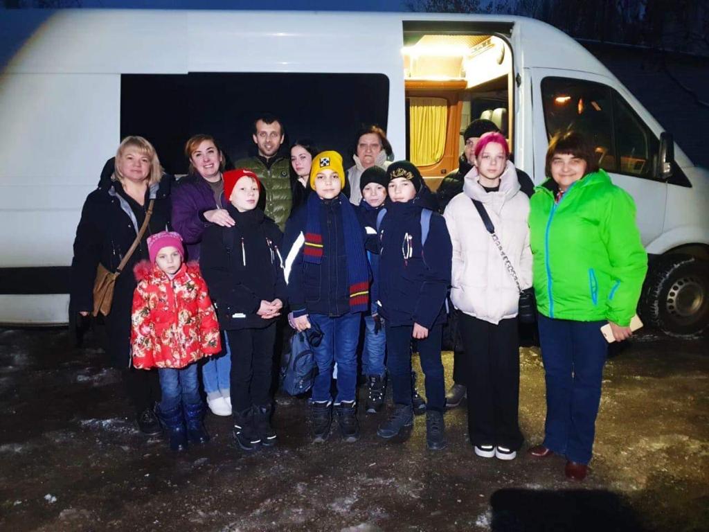 Children standing outside coach