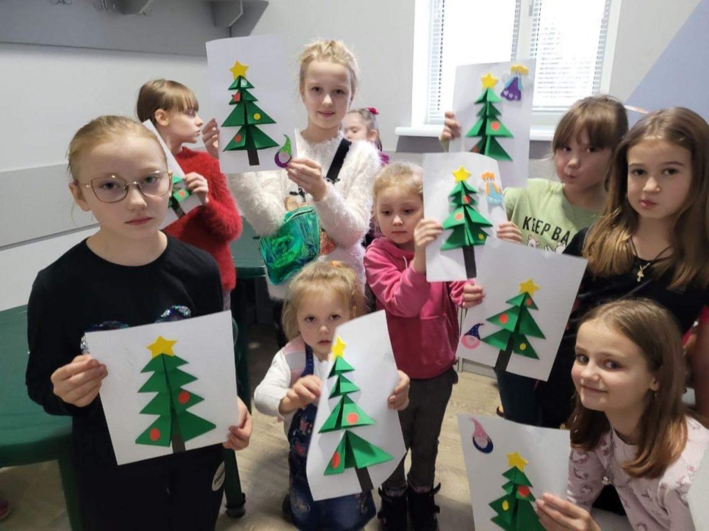 Children holding home made Christmas cards