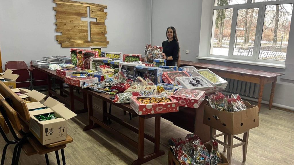 Sorting through tables of Christmas gifts to be given away