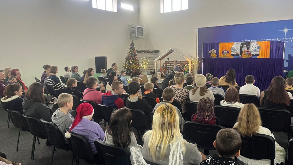 Children watching the puppet show in the Christmas 2022 camp