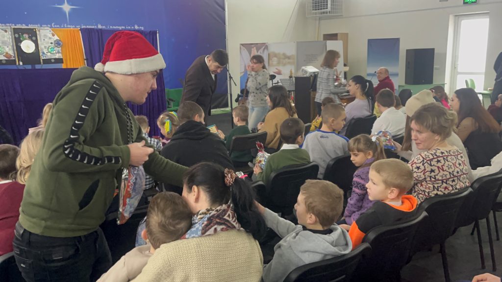 Children receiving their presents at the camp Christmas 2022