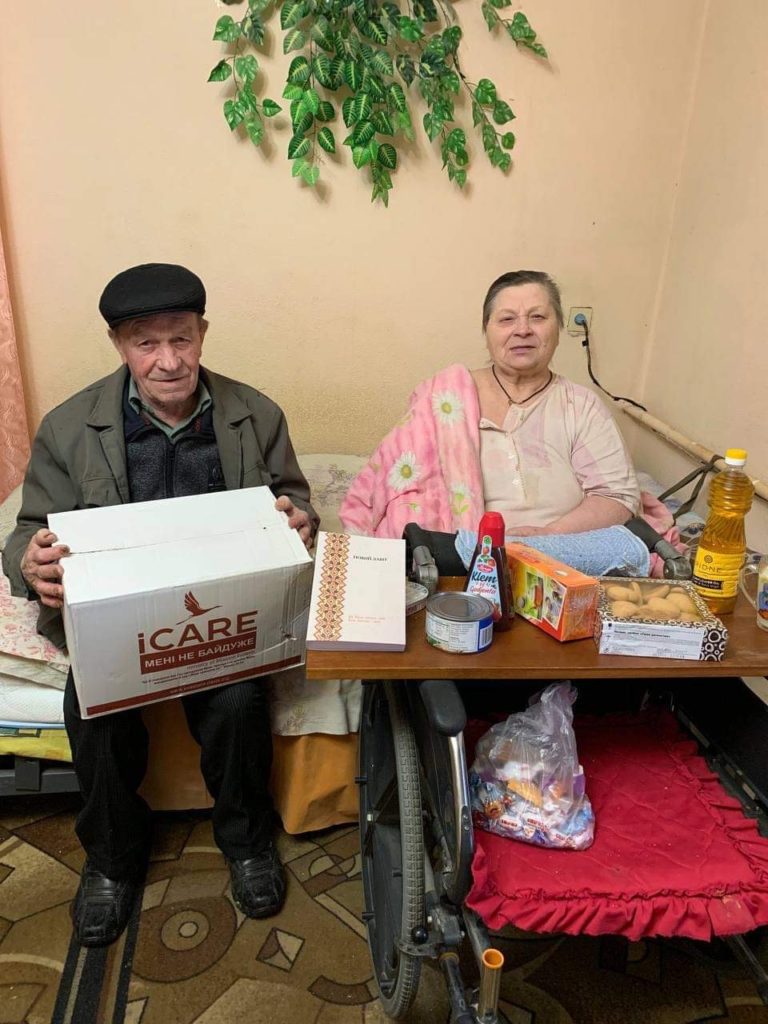 A couple receiving an iCare aid package