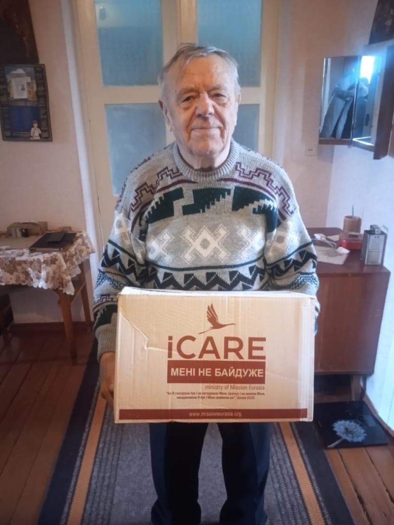 Man holding an iCare aid package