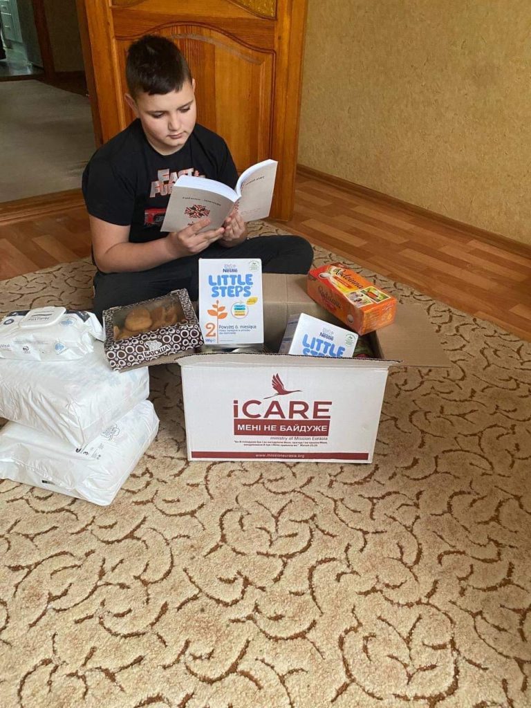 Ratmir's friend reading the books and Bible he has been given.