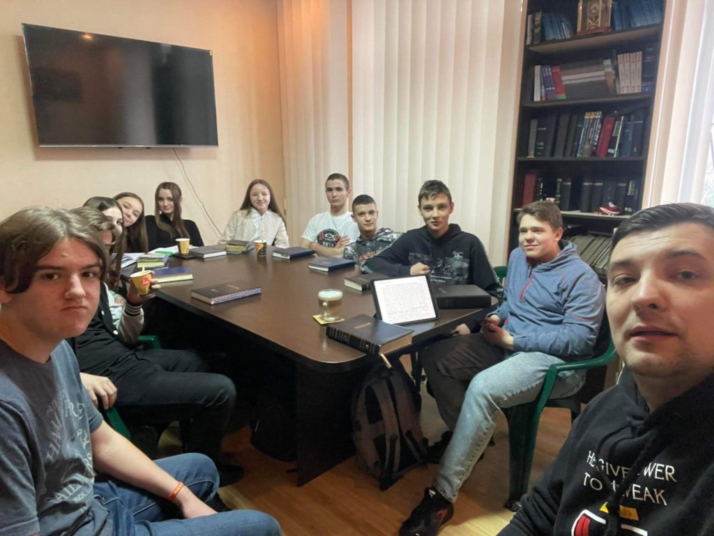 Teens around a table during a Bible study