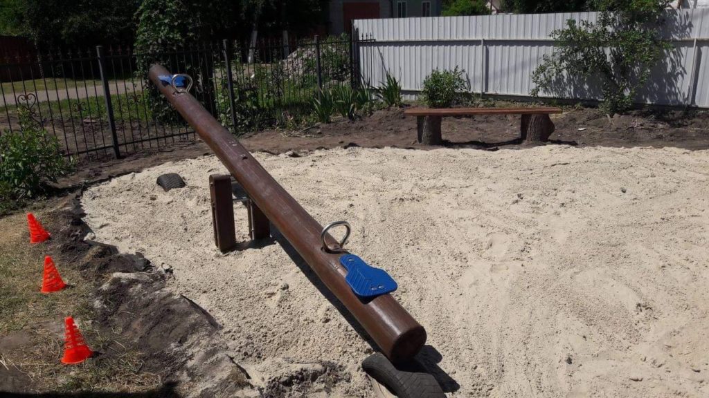 An empty see-saw in a newly installed children's playground