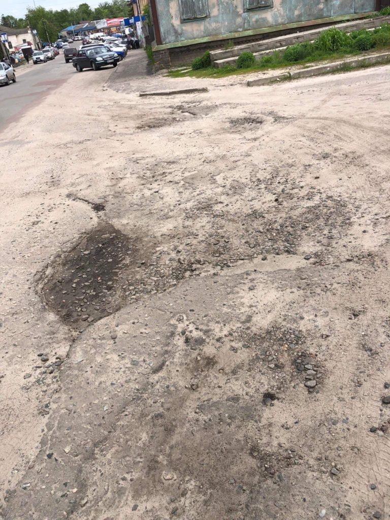 A picture of the poor state of the roads in the village which are covered in pot holes