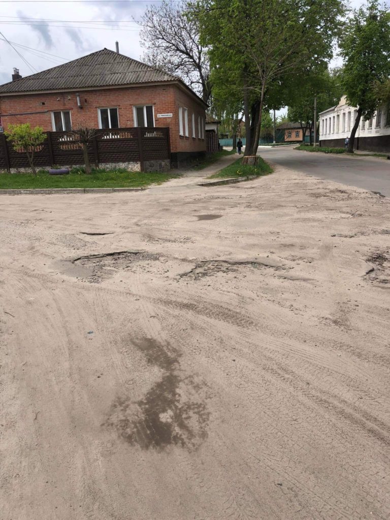 A picture of the poor state of the roads in the village which are covered in pot holes