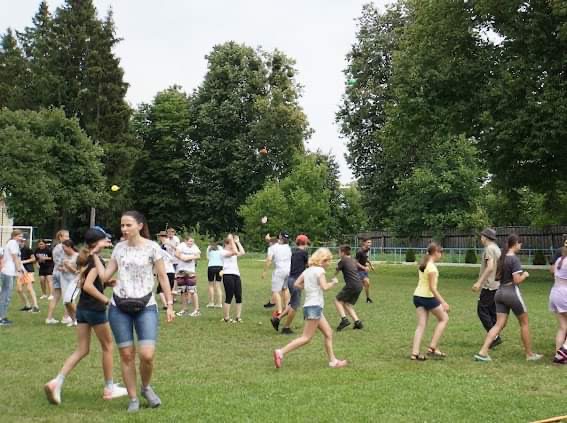 Children Running around the field at the Centre playing a game during the teenagers Summer Camp 2023