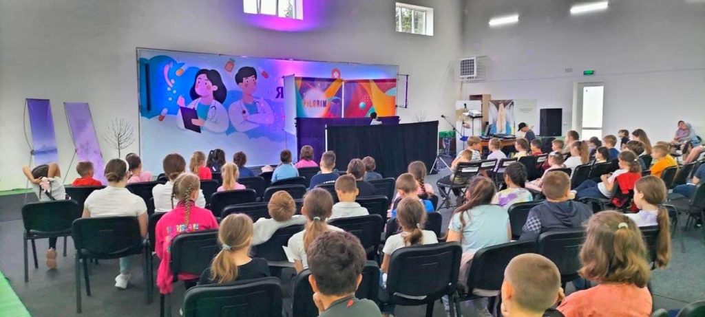 Children seated in the Centre watching a puppet show