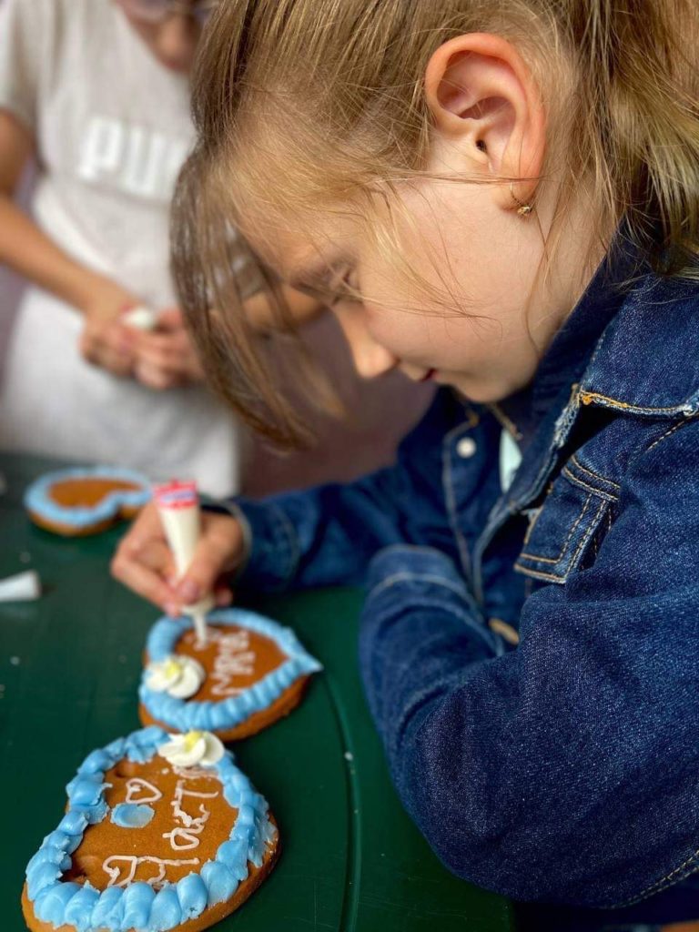 A girl decorating biscuits