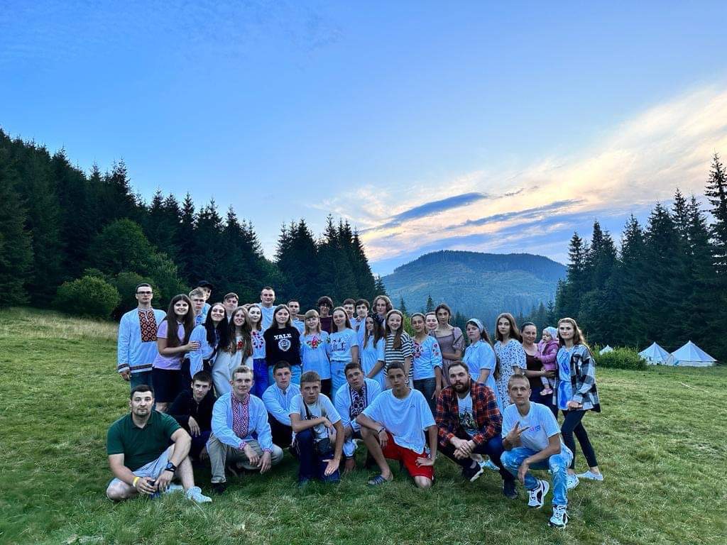 Bohdan and the older children standing in a field at the camp in the Carpathian mountains