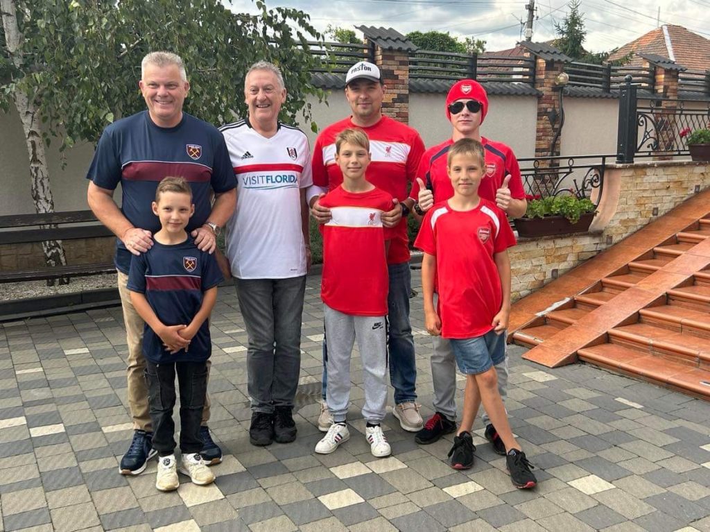 All the boys standing in their new football shirts