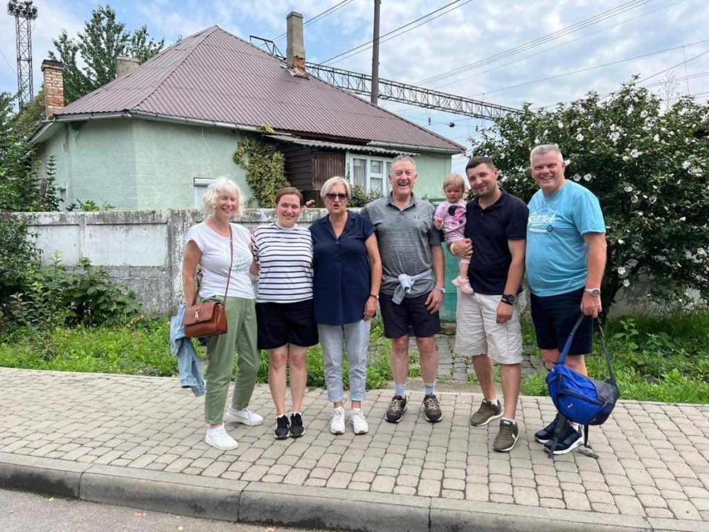 Peter, Karen, Jez, Sandra, Bohdan and Alla standing on the pavement outside the train station following their arrival in Mukachevo