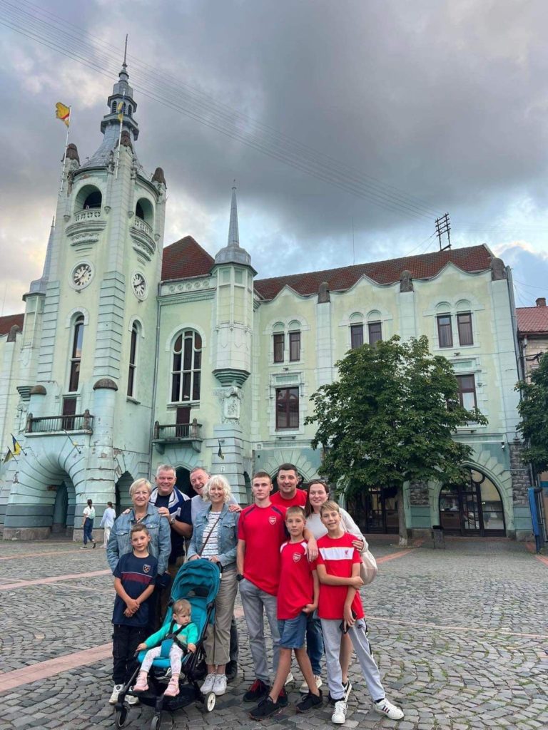 Peter, Karen, Jez, Sandra, Farmer Sergey, Bohdan, Alla and their family standing in the church square in Mukachevo.