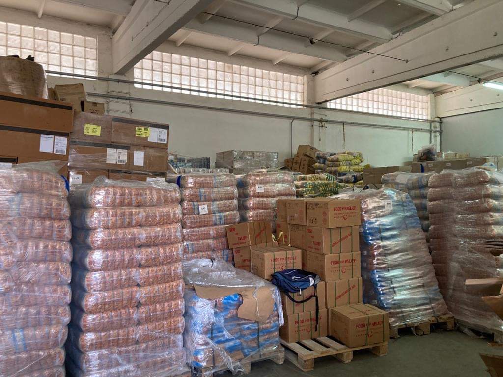 Pallets of food and aid inside the iCare distribution warehouse