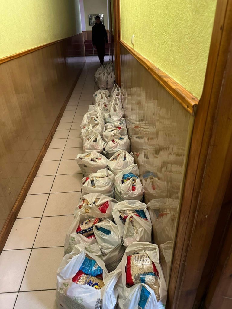 A long line of bags of food aid lined up in a corridor at the Centre ready to be handed out