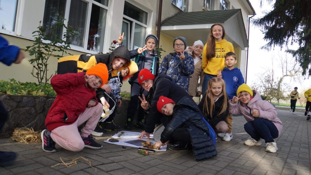Children at the Autumn 2023 camp doing an activity outside.