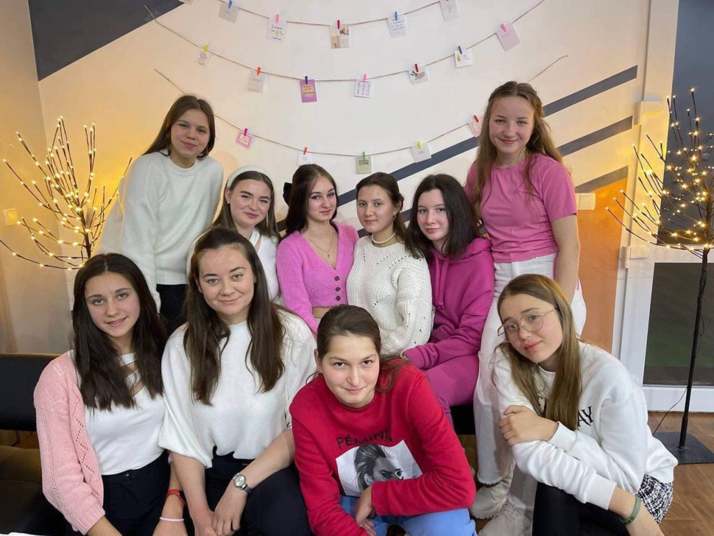 Svitlana and Lyuba hosting a group of girls in the new apartment for a youthgroup meeting