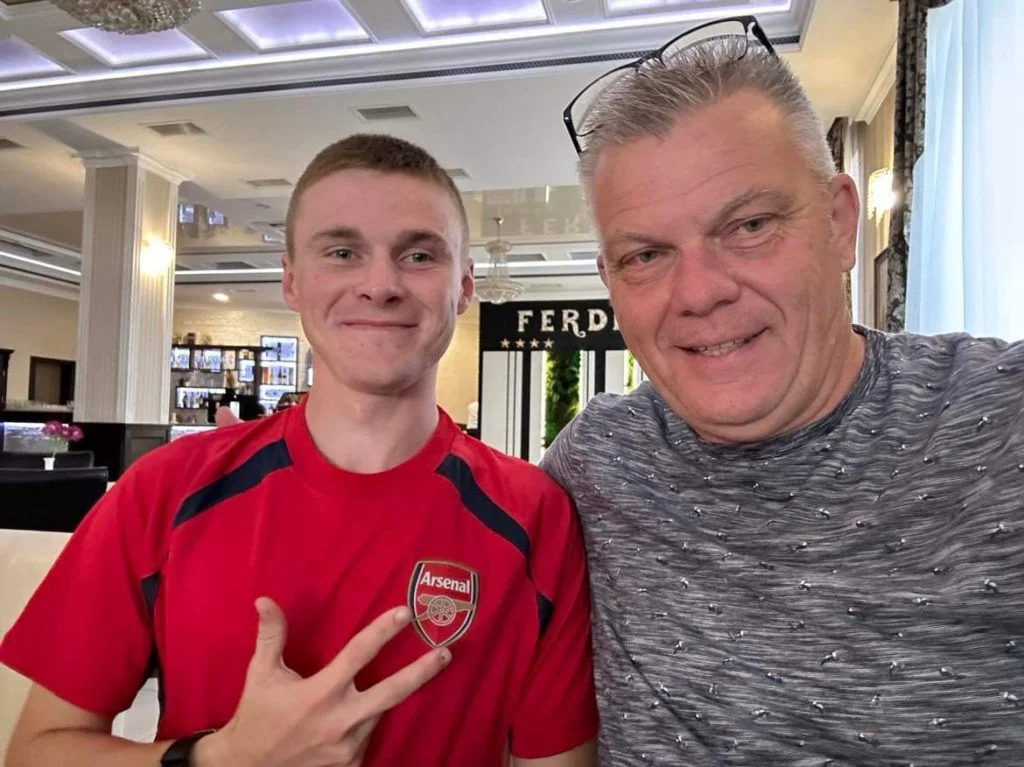 Farmer Sergey and Peter with Sergey proudly pointing at the Arsenal crest on his shirt