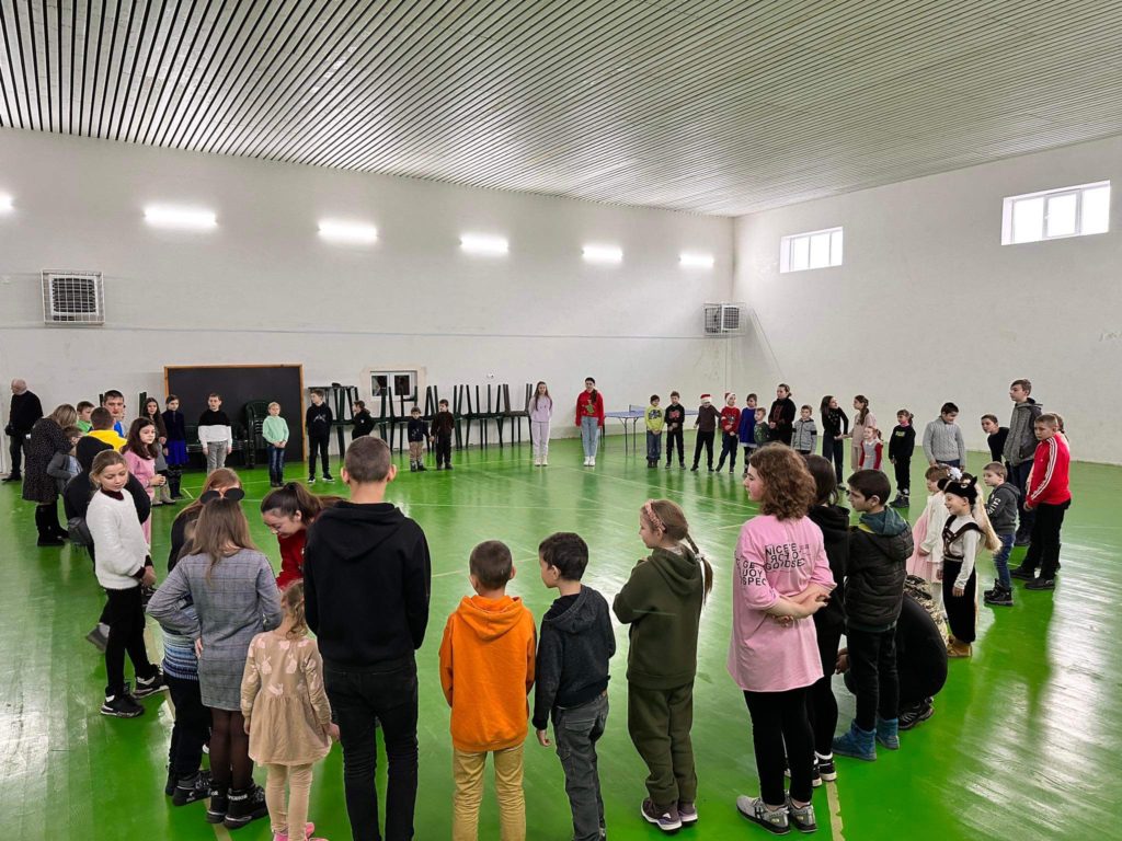 Children stood in a square in the sports hall at the Centre at the event for kids with special needs getting ready to play a game