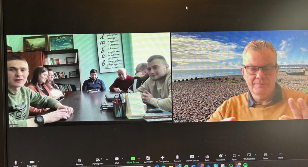 The team in Lebedyn shown on one screen sitting around a table with Peter on another screen whilst on a Zoom call together