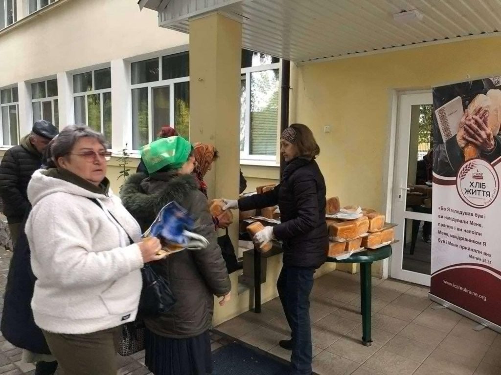 People queuing to receive free bread outside the Centre