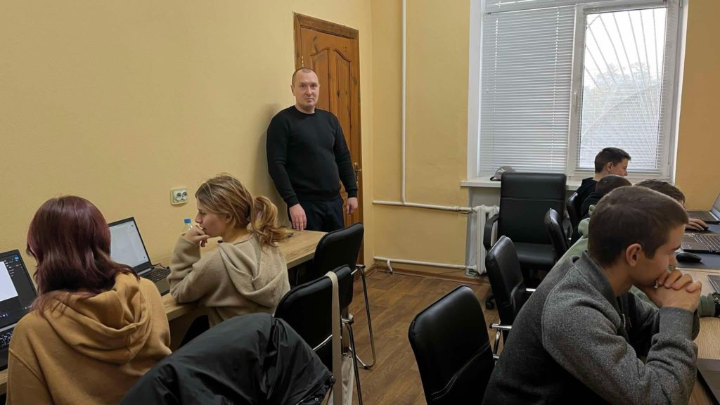 Children sat at computers taking the computer class