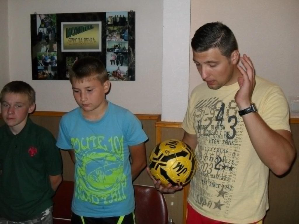 Young Farmer Sergey, Valentine and Bohdan (who is holding a football) at a meeting in 2012