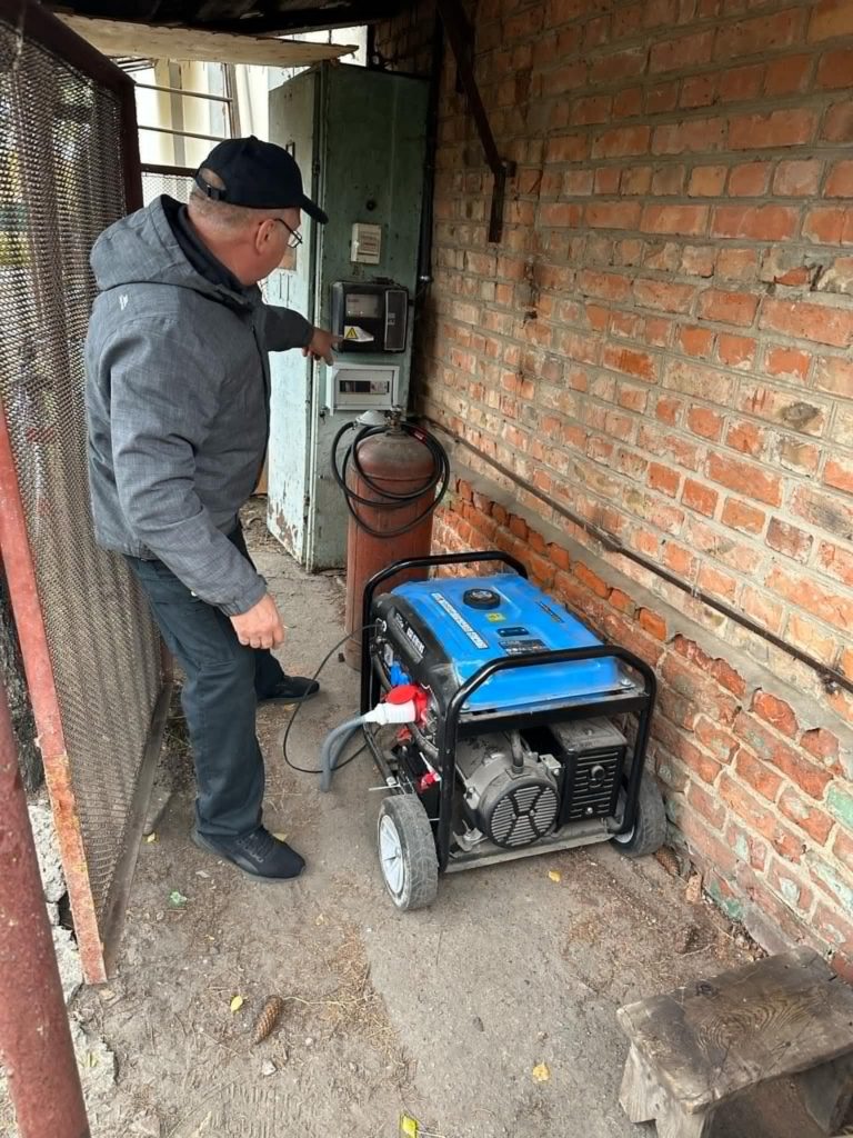 One of the generators in use at the Centre sitting on the ground next to a gas cylinder