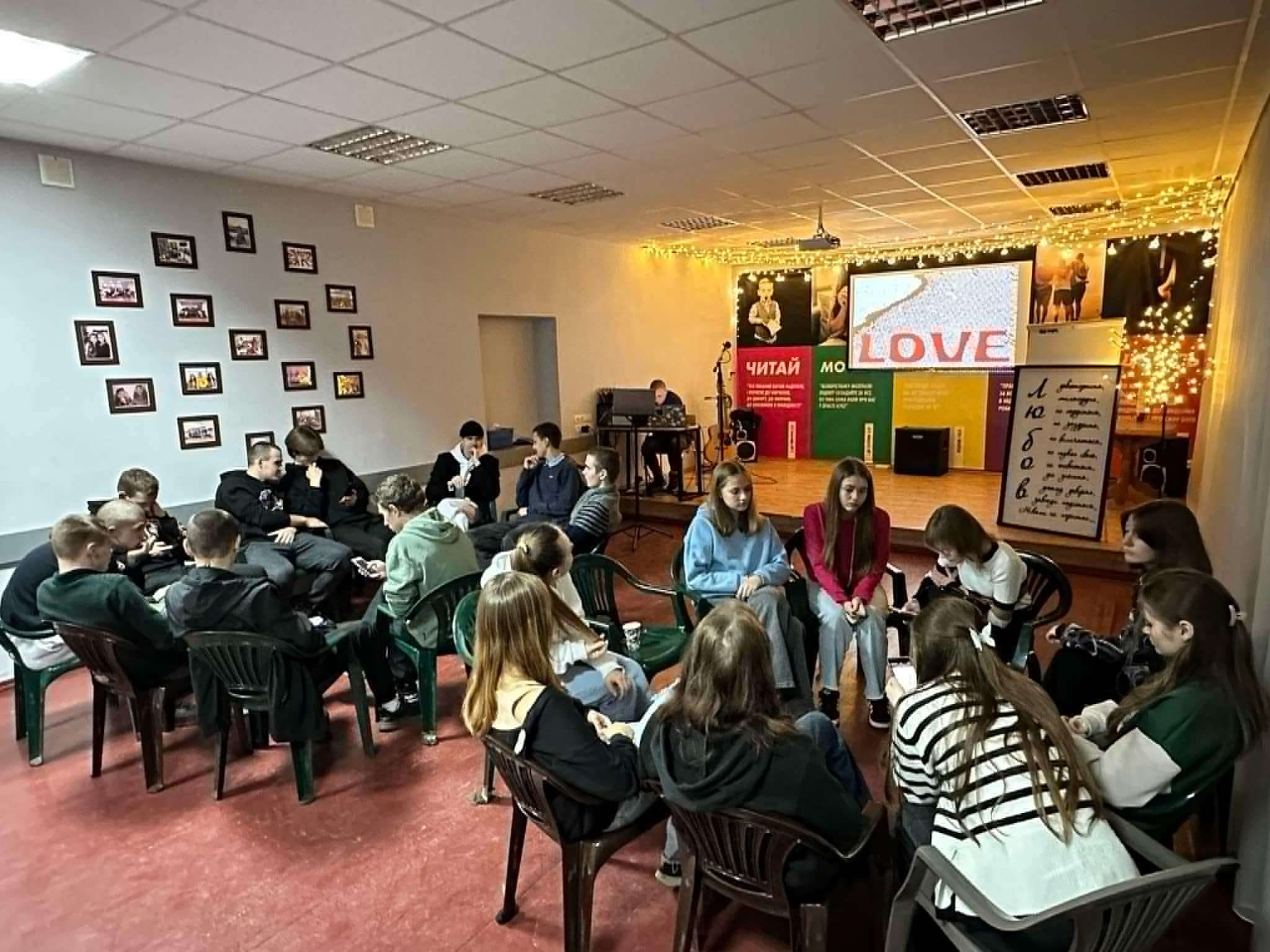 The youth sat in three circles praying at the Centre for their friends in Sumy city