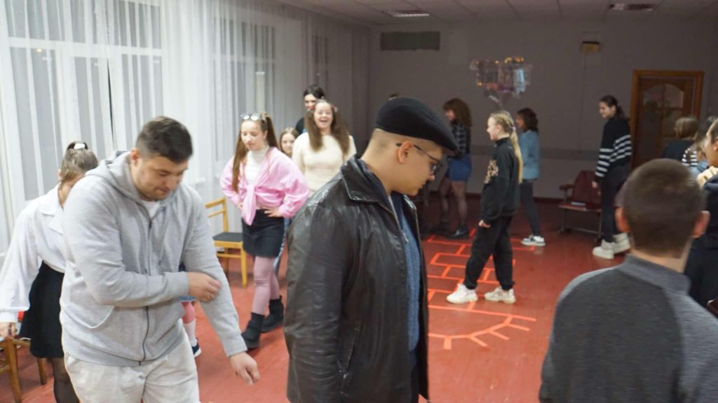 Children and the youth walking in a circle playing a game