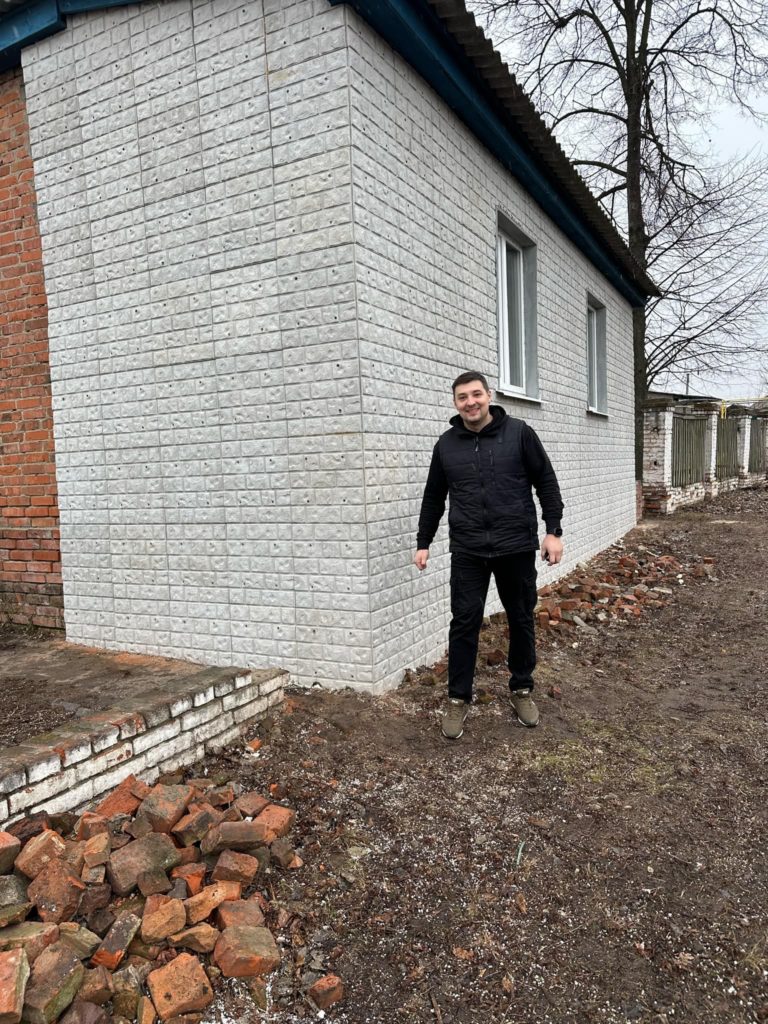 Bohdan walking down the side of the temporary oprhanage building