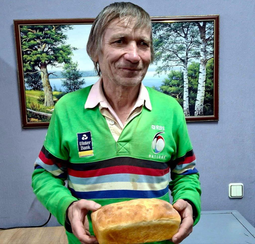 A man holding a loaf of bread