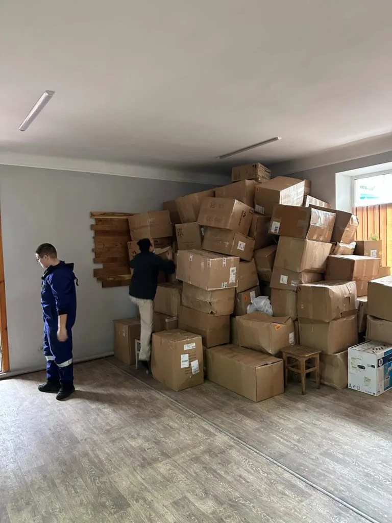 Boxes of aid stacked inside a room piled up to the ceiling