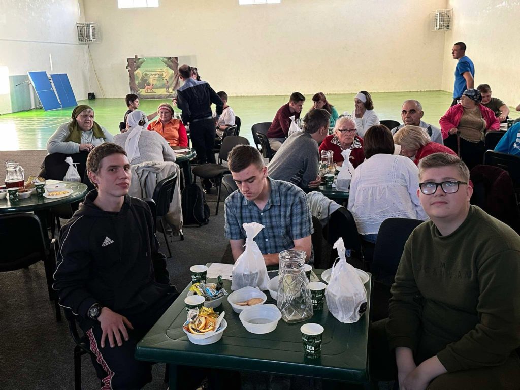 Refugees sat around tables at the Centre