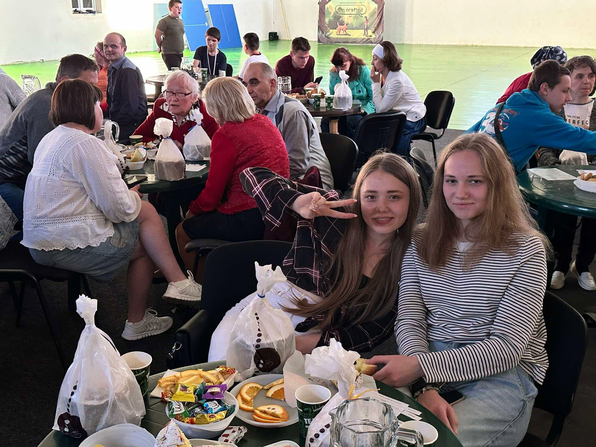 Refugees sat around tables at the Centre