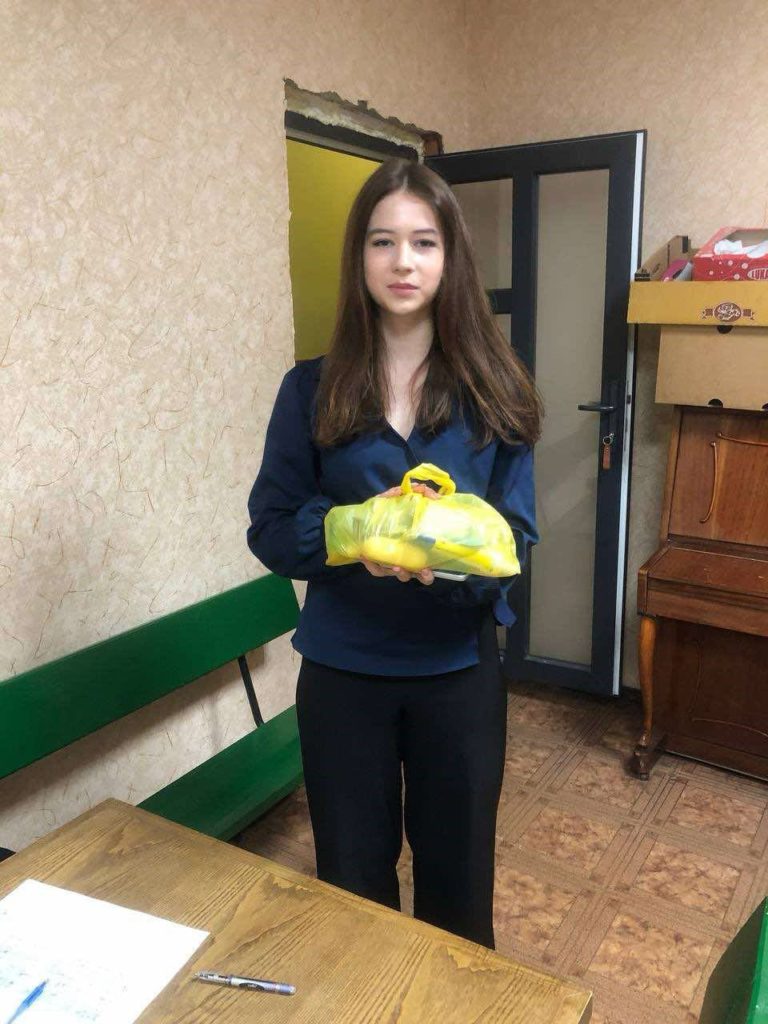 Young lady holding a bag of aid