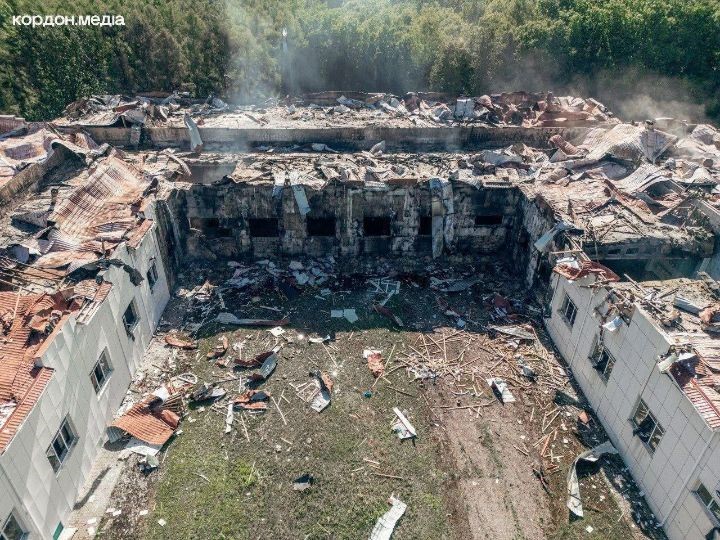 Aerial photo showing the destroyed central section of a university building with smoke rising from the ruins.