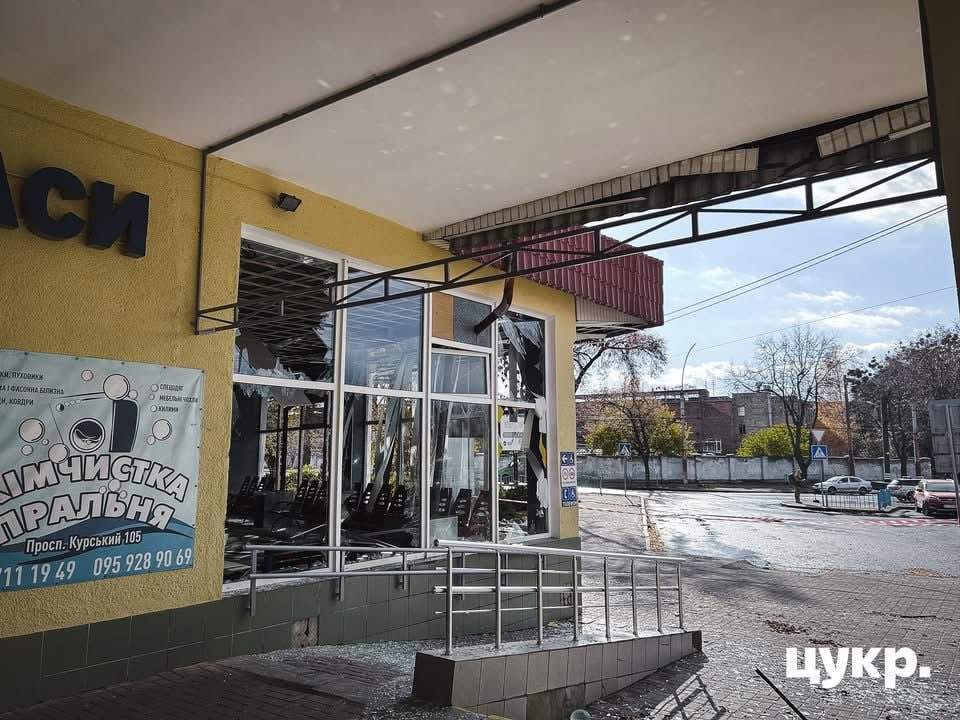 Exterior of a damaged railway station in Sumy with shattered windows and structural damage from bombing during the war in Ukraine.