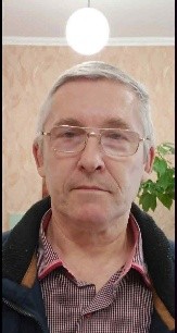 Portrait photo of Mykola wearing glasses and a collared shirt