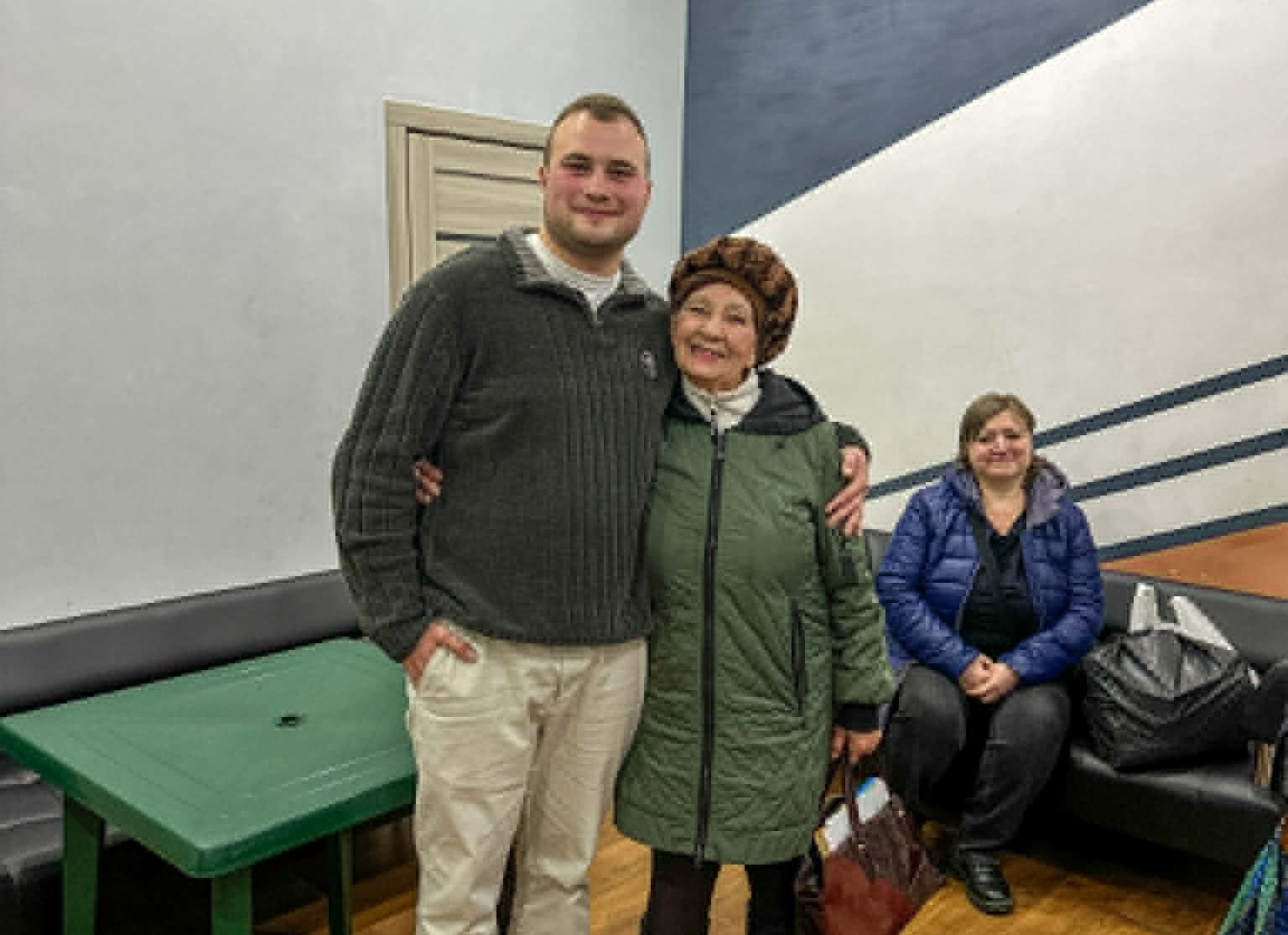 Valentyn and Valentina smiling and standing together inside the Centre.