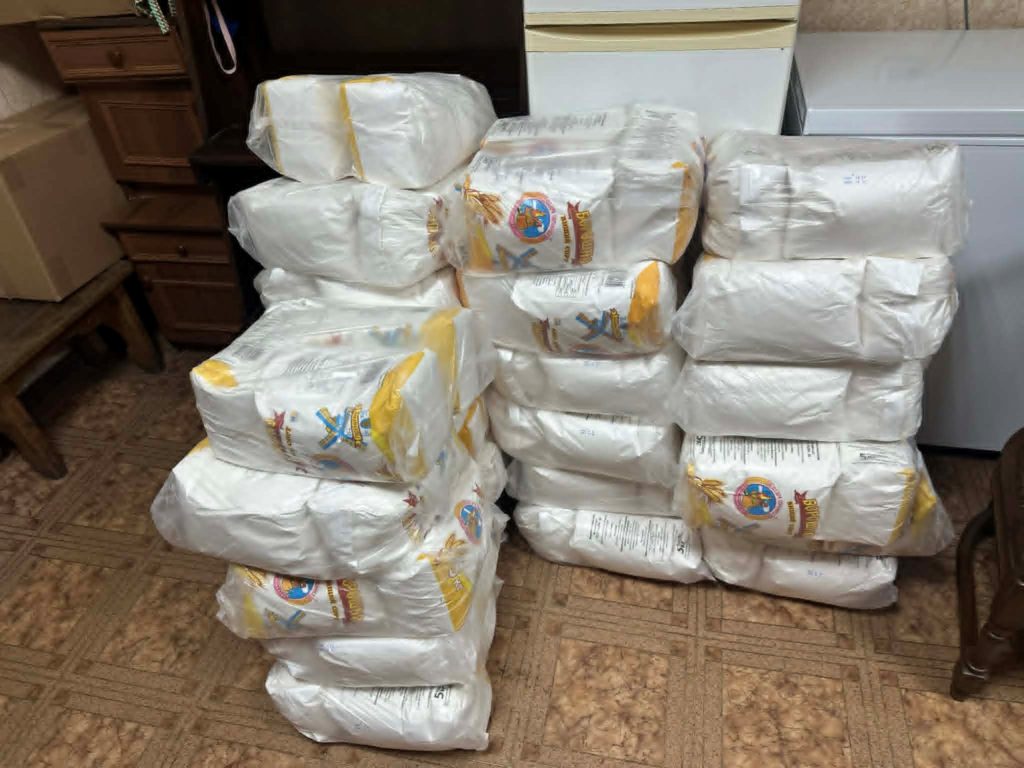 Large stacks of bagged flour supplies stored indoors