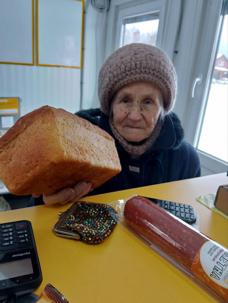 Elderly woman receiving essential food support from the team during winter hardship.