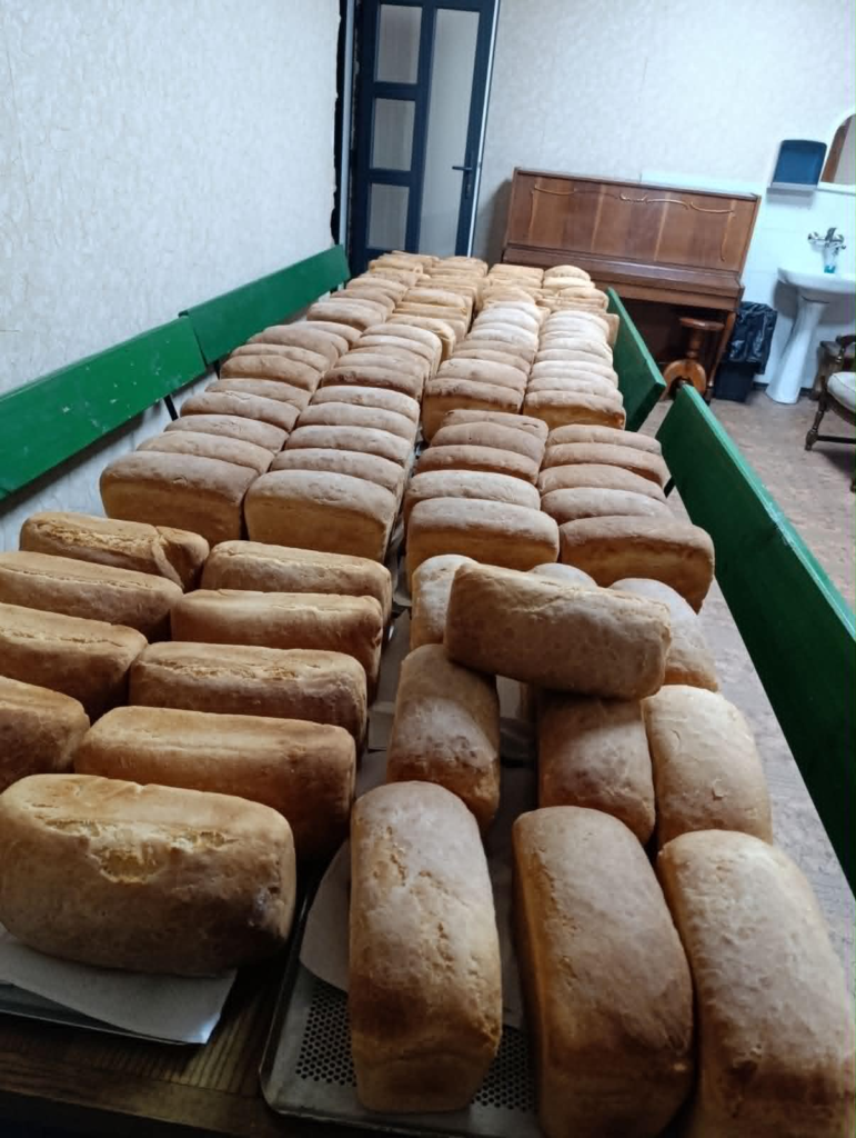 Rows of freshly baked loaves are laid out ready for collection and distribution to local families in need.