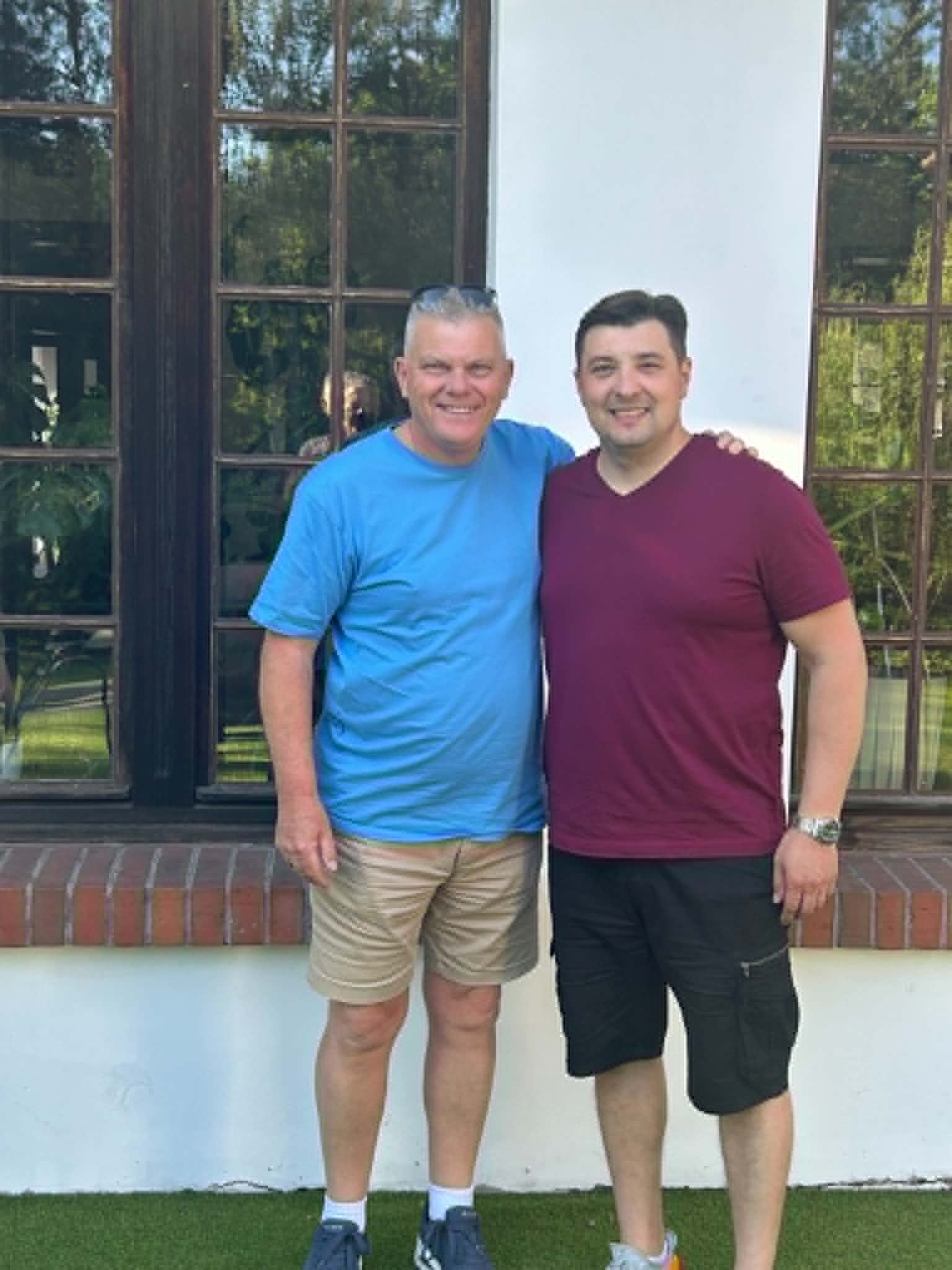 Peter and Bohdan standing side by side posing for the photo.