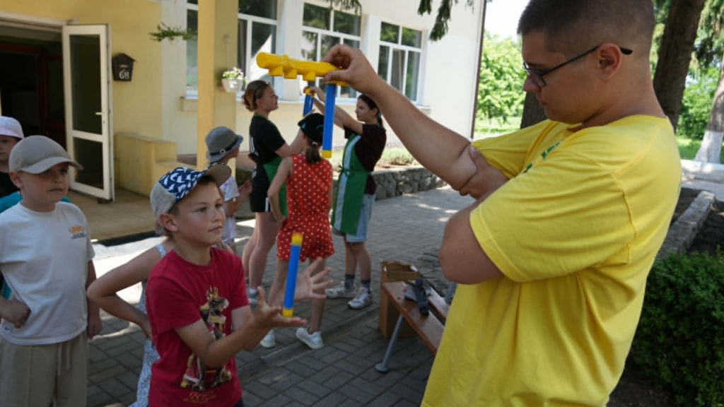 Children take part in a fun teamwork challenge during a summer camp activity.