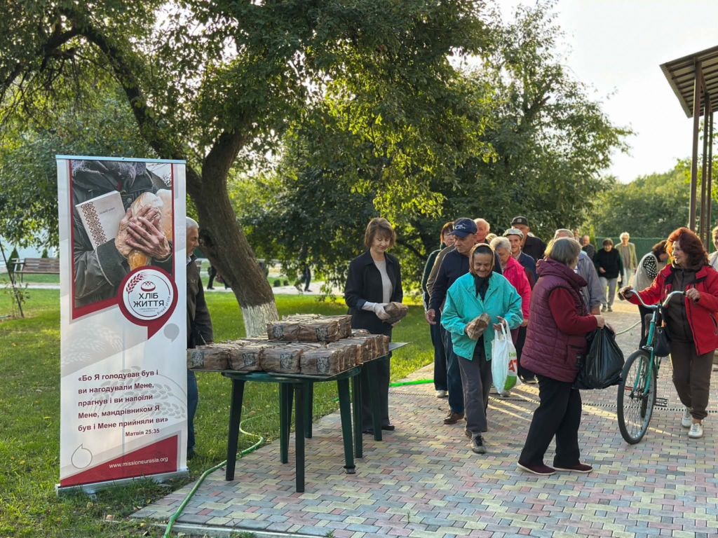 Local people receiving loaves of bread during a food distribution at the Centre
