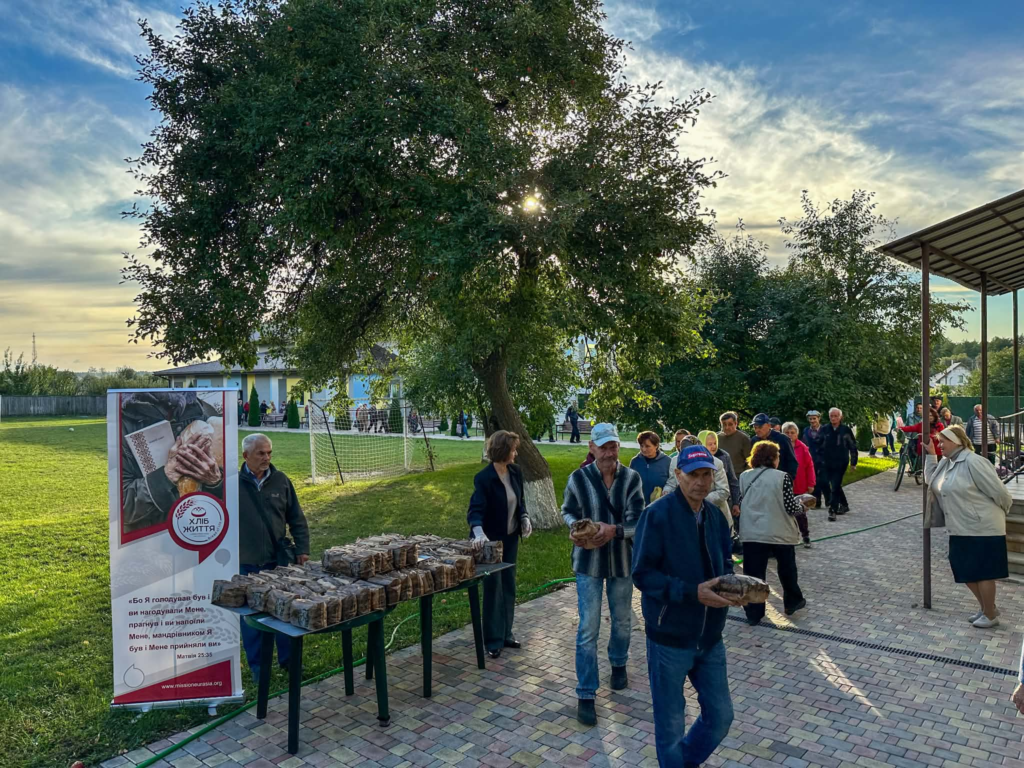 People collecting loaves of bread during a community food distribution at the Centre.