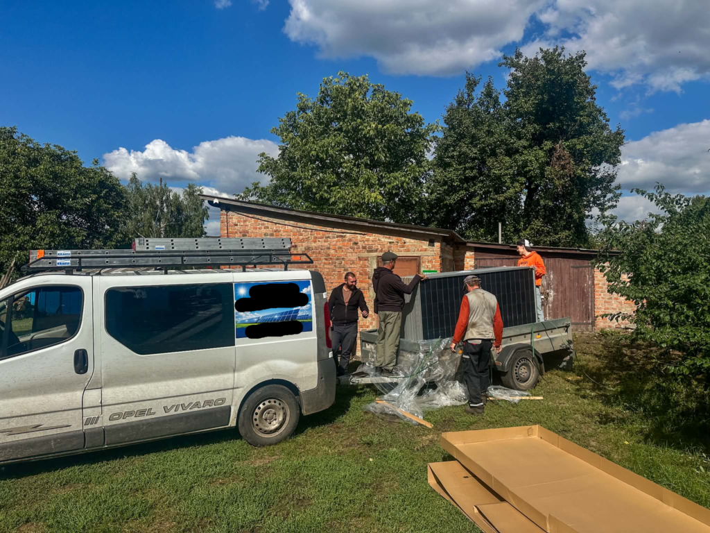 Workers unloading solar panels ready for installation at the Centre.